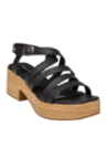 Sandalia de cuero negro con cierre ajustable de hebilla lateral, perfecta para combinar con vestidos largos y faldas midi.