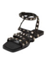Sandalia de cuero negro, ideal para un look punk chic, combinable con jeans o faldas para un aire atrevido.