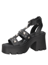 Sandalia negra de cuero para mujer con estilo casual rockero, adornada con tachuelas metálicas para un look punk atrevido.