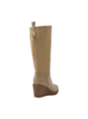 Bota beige de cuero con tacón cuña y detalles rockeros, versátil para eventos diurnos y nocturnos.