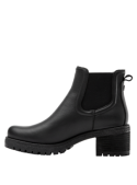 Diseño minimalista de botín negro Chelsea para mujer, con suela antideslizante y tacón medio cuadrado para estabilidad.