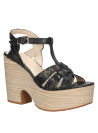 Sandalia negra femenina de cuero con plataforma y cierre de hebilla en el tobillo, adecuada para un estilo casual chic.