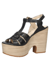 Elegante sandalia de cuero negro con tiras entrecruzadas y tacón ancho, perfecta para combinar con vestidos o faldas midi.