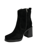 Clásico botín negro de cuero para mujer, diseño funcional con taco medio y estabilidad al caminar, ideal para el día a día.