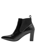 Botín Chelsea negro de cuero para mujer con diseño sofisticado, punta afilada y tacón que brinda estabilidad y comodidad.