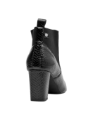 Botín de cuero negro para mujer, estilo Chelsea, tacón cuadrado medio, ideal para moda urbana y look casual chic.