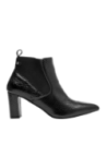 Elegante botín Chelsea de cuero negro para mujer, diseño minimalista con paneles elásticos laterales y tirador trasero.
