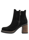 Clásico botín negro de cuero para mujer, estilo Chelsea, perfecto para looks casuales elegantes y ocasiones formales.