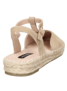 Alpargata beige de cuero para mujer con correa ajustable y suela de esparto trenzado.
