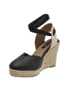 Alpargata de cuero negro para mujer con plataforma de yute y cintas al tobillo.