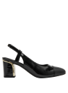 Zapato de cuero negro con contraste de texturas y taco mediano, sofisticado y moderno.