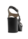 Sandalia femenina de cuero negro con detalle metálico y acabado sofisticado.