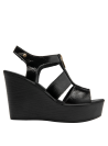 Sandalia de mujer en cuero negro con diseño sofisticado y moderno.