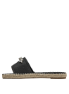Alpargata casual negra con aplicaciones brillantes en textil liso.