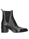 Botín negro de cuero brillante para mujer, estilo urbano, recomendado para salidas informales.